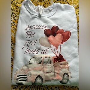 White Graphic Sweatshirt "Because He First Loved Us" with Pink Heart Balloons